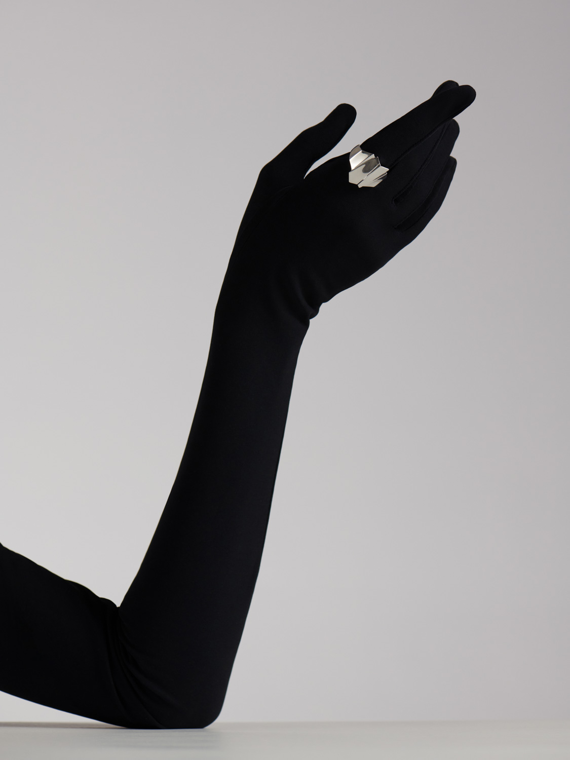 After retouch — black gloved arm, shadow and contrast refined for clean editorial look