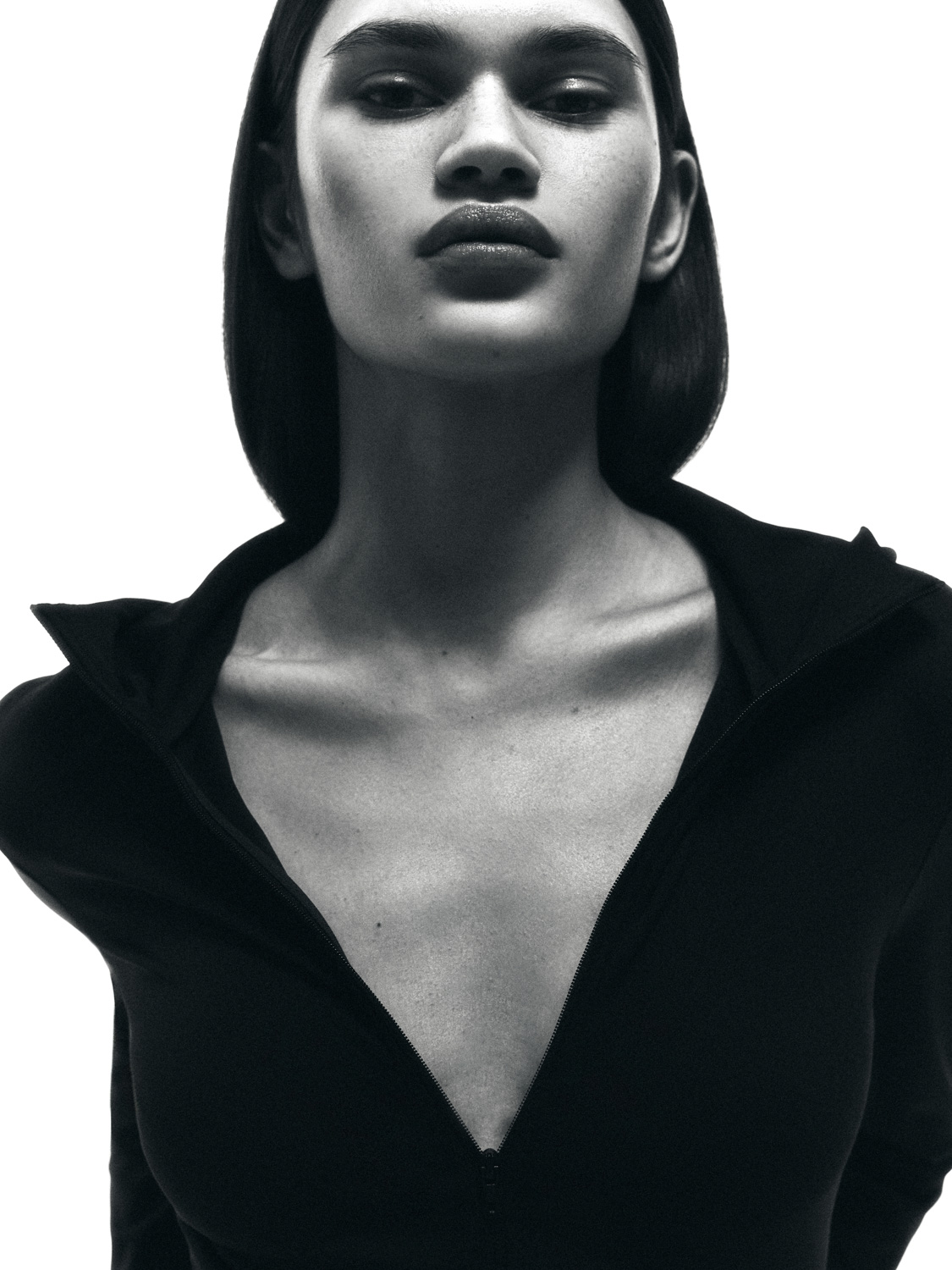 After retouch — B&W close-up, skin retouched to smooth even tone while preserving graphic mood