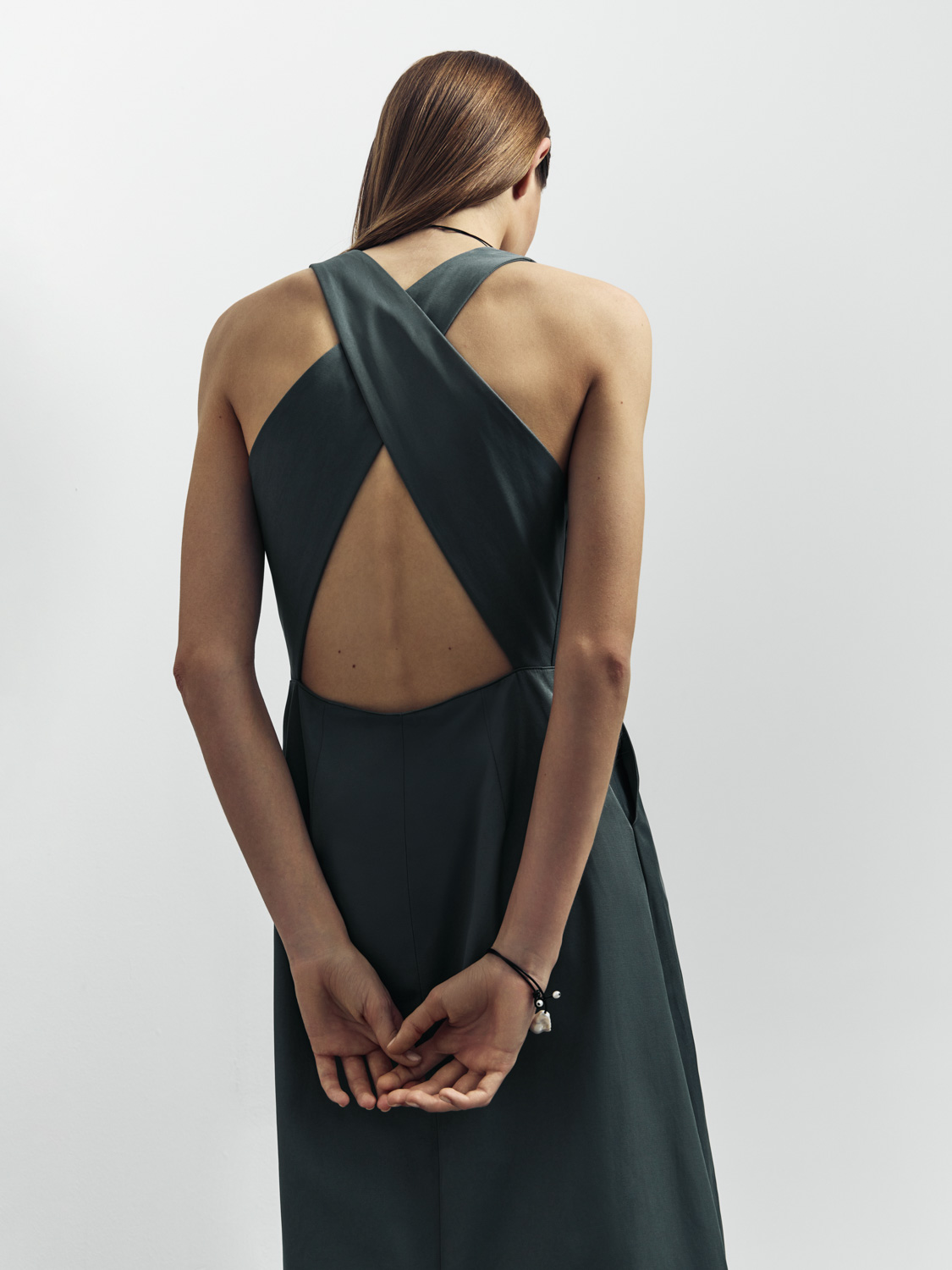 After retouch — same crossback dress, back view, skin and fabric refined for clean catalog result
