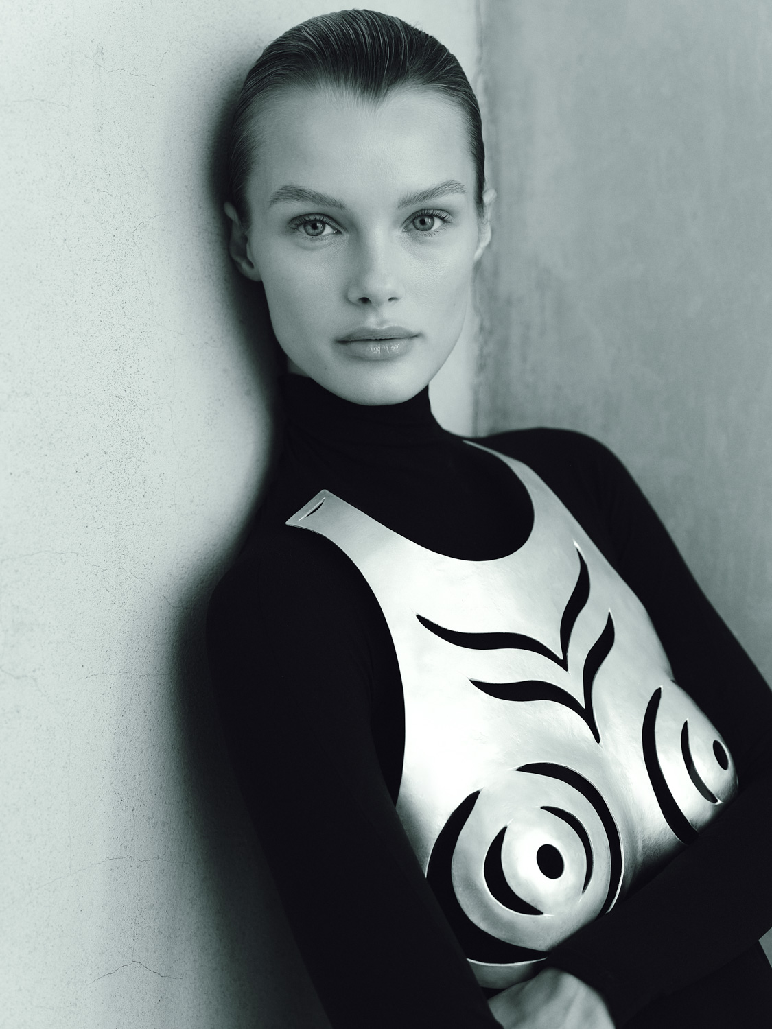 Atelier Biser — B&W portrait in black turtleneck and sculptural silver breastplate